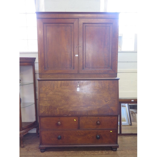 60 - An early 19th century mahogany secretaire cabinet, the pair of panelled doors enclosing adjustable s... 