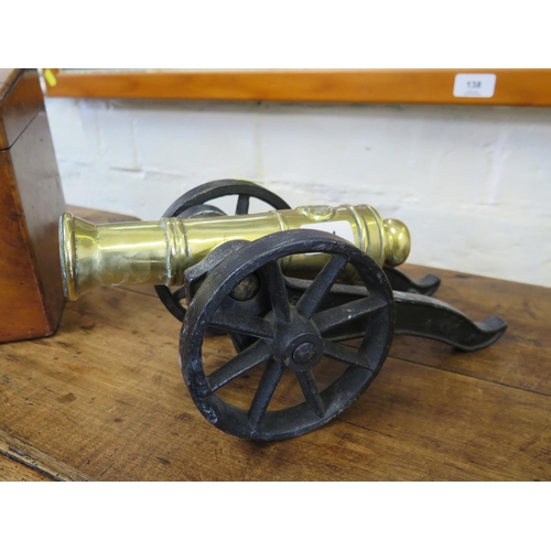 144 - A miniature brass cannon on a metal carriage, 34cm long