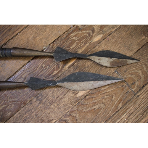 210 - Two double headed spears, possibly African, with spiral turned wood shafts, 135 cm long (2)