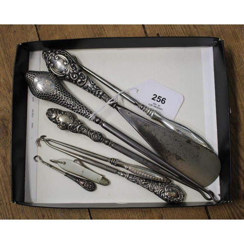 256 - Six silver handled button hooks, a mother of pearl folding button hook and a silver handled shoe hor... 