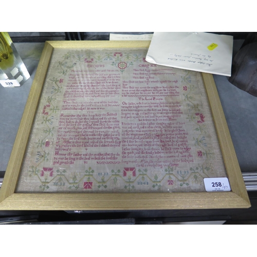 258 - A 19th century lace table cloth, a child's lace bonnet, other textiles and a framed sampler quoting ... 