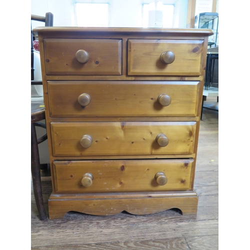 26 - A pine chest of drawers, with two short and three long drawers on a shaped plinth base, 66 cm wide, ... 