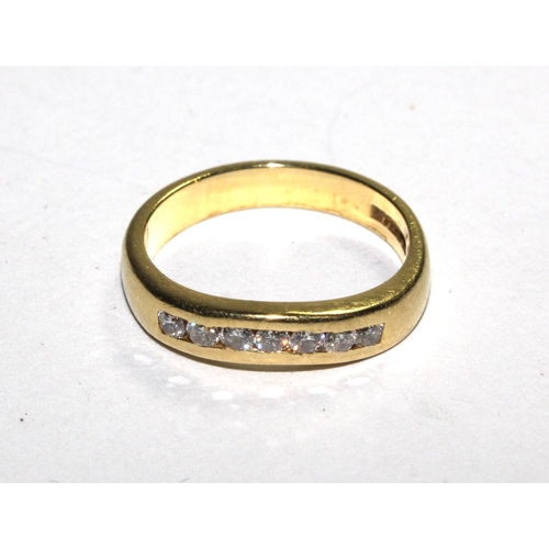 515 - An 18 carat yellow gold ring set with seven round diamonds