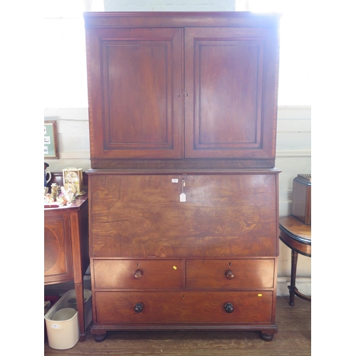 60 - An early 19th century mahogany secretaire cabinet, the pair of panelled doors enclosing adjustable s... 