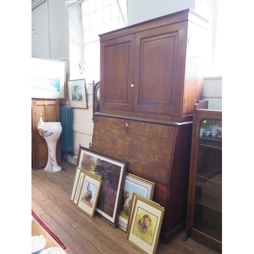 60 - An early 19th century mahogany secretaire cabinet, the pair of panelled doors enclosing adjustable s... 