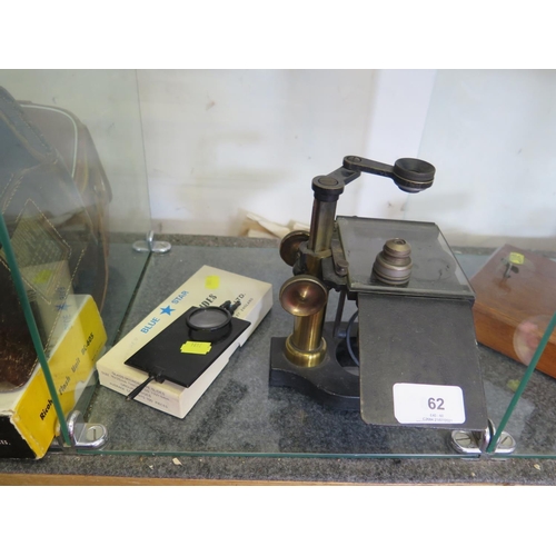 69 - A brass and metal dissecting microscope, with glass top platform and accessories, 19 cm high extende... 