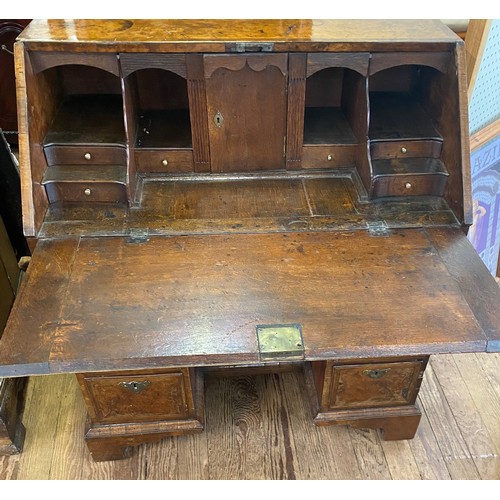 21 - A George I Walnut Kneehole Desk. Circa 1720. With a fall front opening to reveal a fitted interior a... 