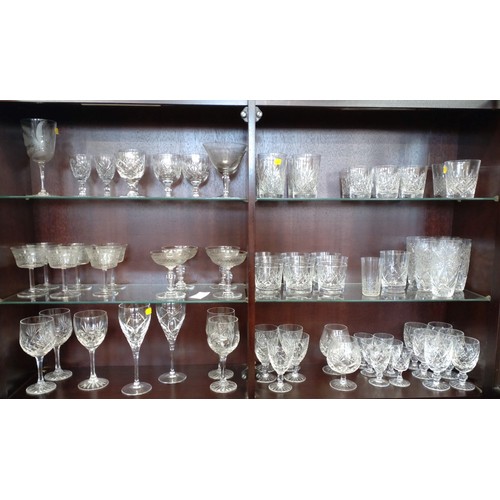 A large selection of cutglass drinking glasses, some sets, some port