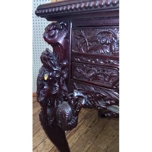 65 - A Chinese centre table. Vintage. heavily carved throughout.  78 x 86 x 70cm.