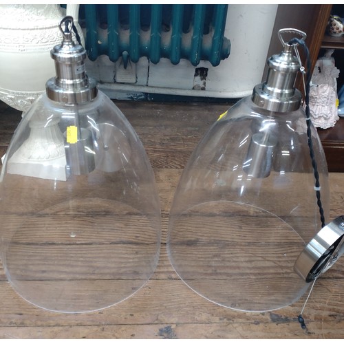 69 - Two modern glass lampshades with ceiling fittings