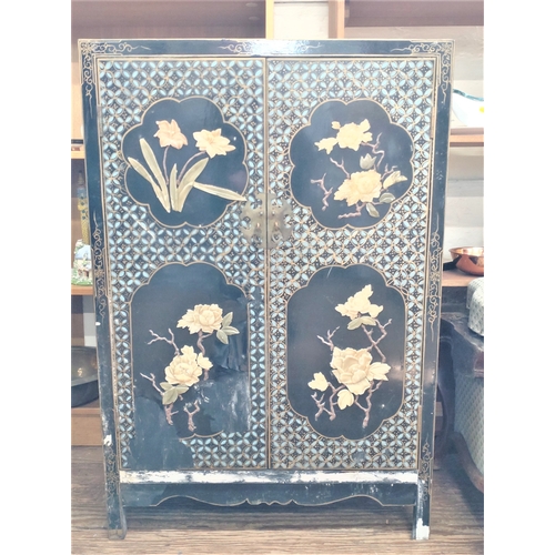 540 - A Vintage Chinese lacquered Two door Cabinet. Decorated in high relief with flowers. 95cm x 65cm x 3... 