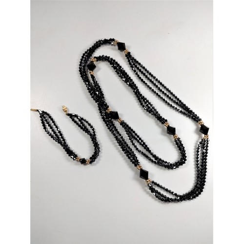 1042 - An elegant triple-strand black cut bead necklace with matching bracelet, both with 9ct gold clasps a... 