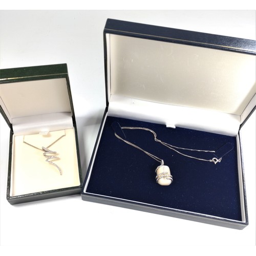 1046 - Two silver chain necklaces, one with a mother of pearl pendant, the other a spiral pendant. Both set... 