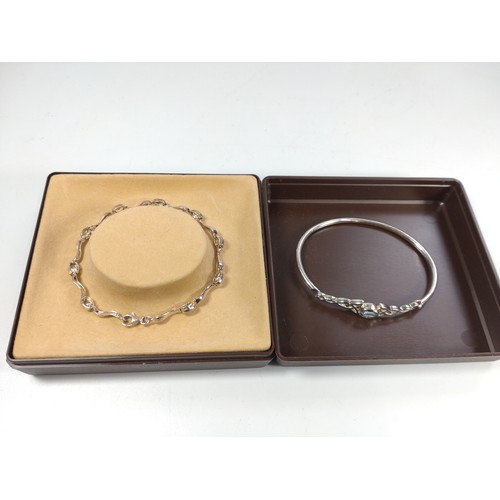 1045 - Two silver bracelets set with stones in a box.