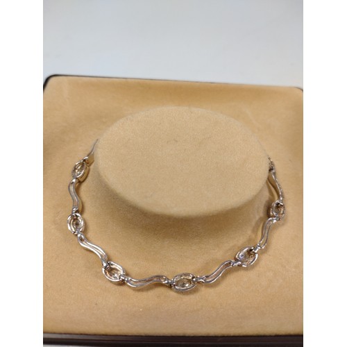 1045 - Two silver bracelets set with stones in a box.