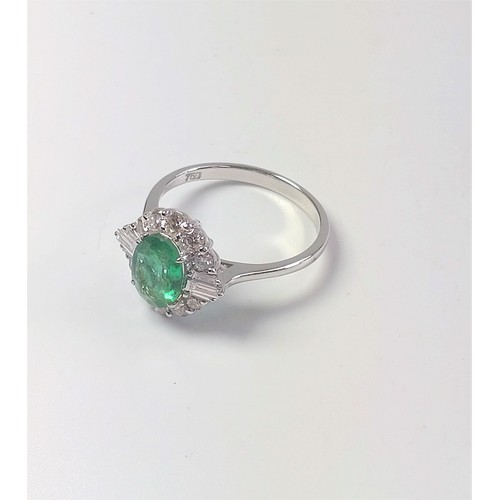 1069 - An 18ct white gold ring set with oval emerald, Round Brilliant Cut and tapered baguette diamonds. Em... 