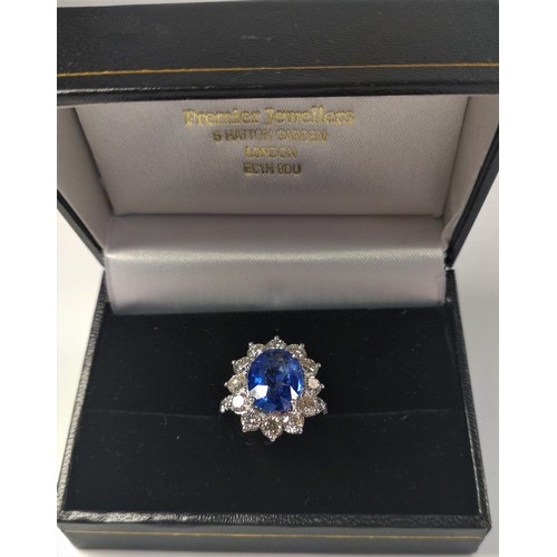 1073 - An 18ct white gold large oval sapphire and Round Brilliant Cut diamond cluster ring and shoulders, b... 