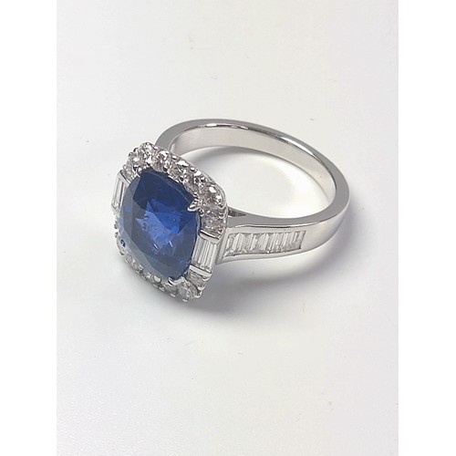 1074 - An 18ct white gold ring set with rectangular cushion sapphire surrounded by Round Brilliant Cut and ... 