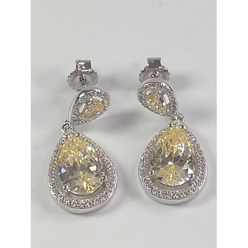 1056 - A pair of silver pear shape drop earrings with central yellow pear shaped CZ and white round CZ halo... 