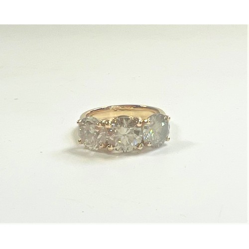 1076 - An 18ct yellow gold round brilliant diamond trilogy ring. Diamonds 4.79ct. original WGI Cert no. WGI... 