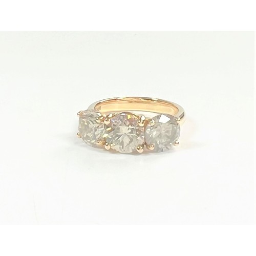 1076 - An 18ct yellow gold round brilliant diamond trilogy ring. Diamonds 4.79ct. original WGI Cert no. WGI... 