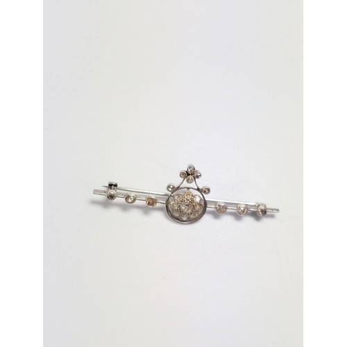 524 - A diamond brooch set in high cart white metal.  50mm long. 3.65 grams.