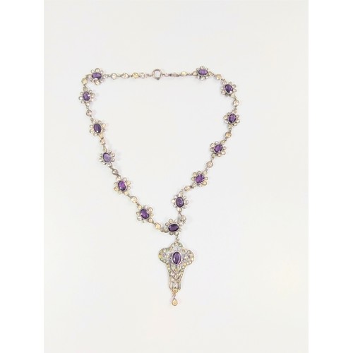 525 - An Amethyst and white stone set necklace. Early 20th century. 24cm drop.