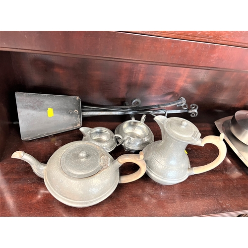 106 - A four piece pewter tea set and some fire irons.