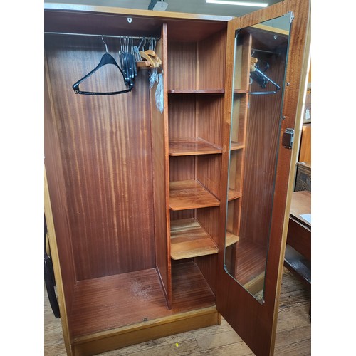 4 - A large mid-century two-door wardrobe with hanging space, four shelves and a mirror attached inside ... 