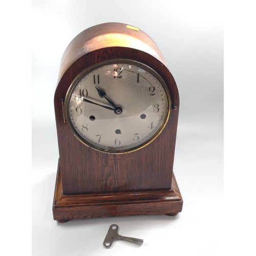 86 - An oak mantel clock with Westminster chime