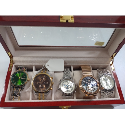 436 - A collection of five fashion watches in a wooden presentation case.