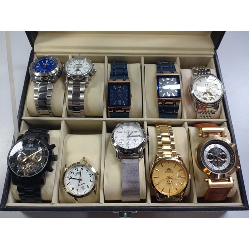 437 - A collection of ten fashion watches in a leather presentation case