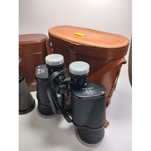 116 - Two pairs of binoculars and a gentleman's grooming case