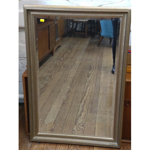 74 - A modern gilt framed bevelled mirror. 98cm x 66cm