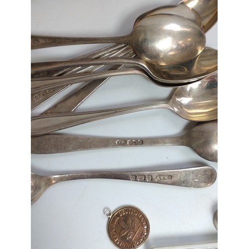 159 - A miscellaneous lot including ten silver teaspoons, a silver sieve spoon with mother of pearl handle... 