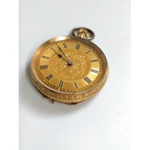 445 - An 18ct gold fob watch. Bright cut engraved case. 35mm diameter