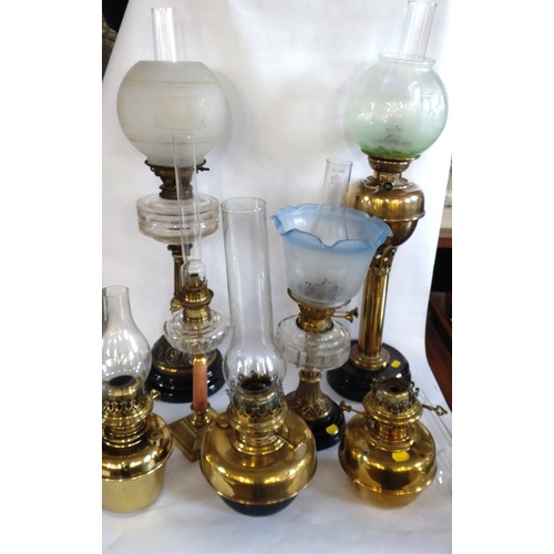 71 - A group of seven various Victorian oil lamps. (one lacking shade). Tallest 76cm