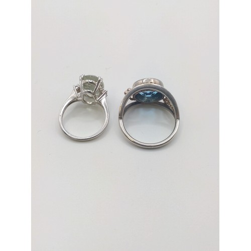 304 - A silver and green amethyst (prasiolite) dress ring, size L 1/2, together with a white metal and blu... 