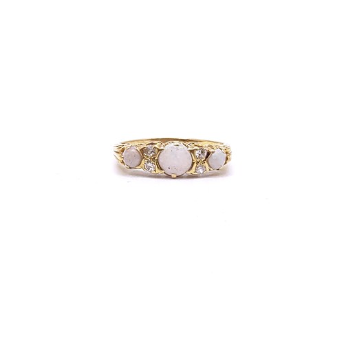 294 - An 18ct yellow gold, opal, and diamond ring, the carved mount set with three round cabochon opals an... 