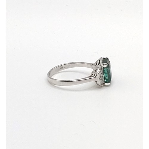 302 - An 18ct white gold, diamond, and emerald ring, in Art Deco taste, set with a mixed emerald-cut emera... 