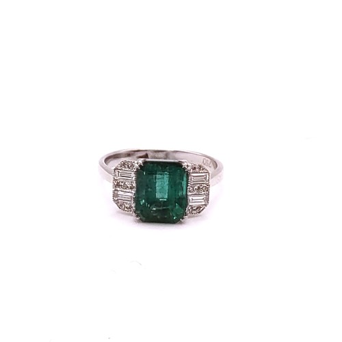 302 - An 18ct white gold, diamond, and emerald ring, in Art Deco taste, set with a mixed emerald-cut emera... 