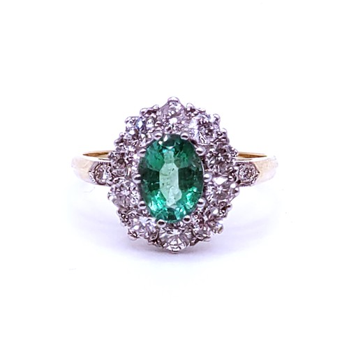 296 - An 18ct yellow gold, diamond, and emerald cluster ring, set with a mixed oval-cut emerald of approxi... 