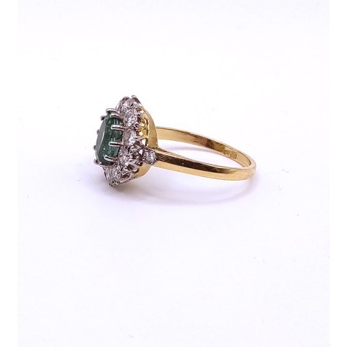 296 - An 18ct yellow gold, diamond, and emerald cluster ring, set with a mixed oval-cut emerald of approxi... 