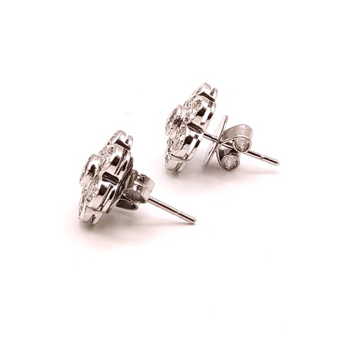 293 - A pair of 18ct white gold and diamond floral cluster ear studs, the round brilliant-cut diamonds of ... 