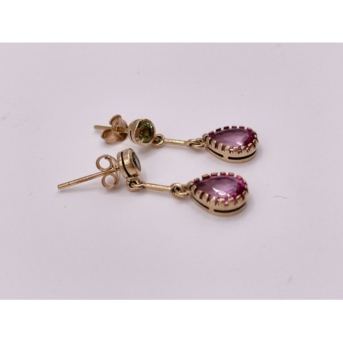 288 - A pair of 9ct yellow gold, pink topaz, and peridot drop earrings, each collet-set with a round-cut p... 