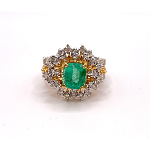 311 - A yellow gold, diamond, and emerald cocktail ring, set with a mixed-cut emerald, measuring approxima... 