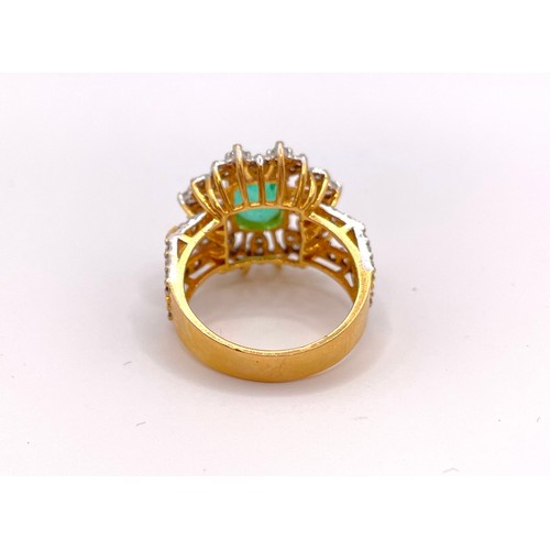 311 - A yellow gold, diamond, and emerald cocktail ring, set with a mixed-cut emerald, measuring approxima... 