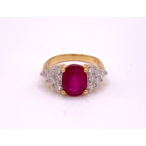 308 - An 18ct yellow gold, diamond, and ruby ring, set with a mixed oval-cut ruby, of approximately 3.50 c... 