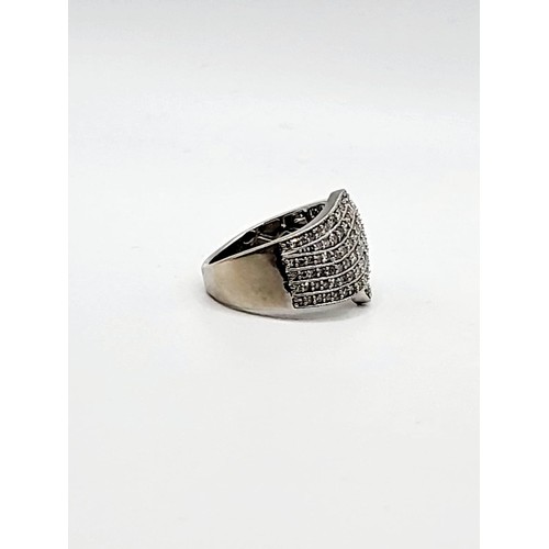 303 - An 18ct white gold and diamond cocktail ring, the crossover design pave-set with round brilliant-cut... 