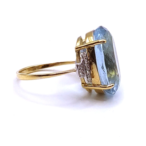 301 - An 18ct yellow gold, diamond, and aquamarine cocktail ring, set with a mixed oval-cut aquamarine of ... 